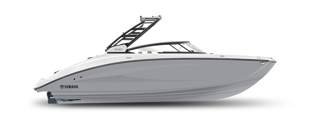 Side profile of a sleek and modern Phil Dill Boats 252S model, with a white and navy blue color scheme and a spacious deck area.