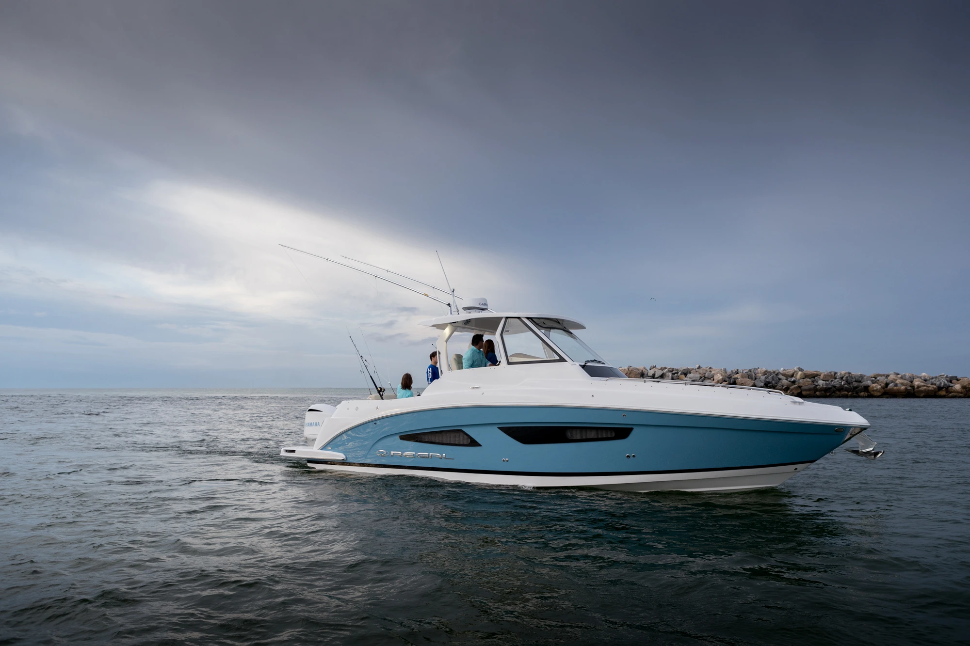 A sleek and stylish 33-foot boat cruising through calm blue waters.